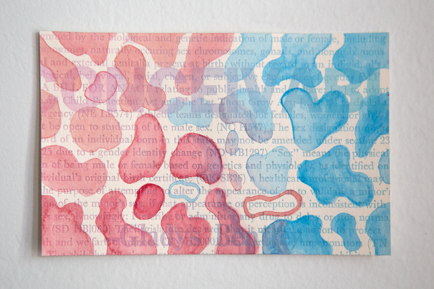 watercolor of red and blue blobs over letterpress printed text